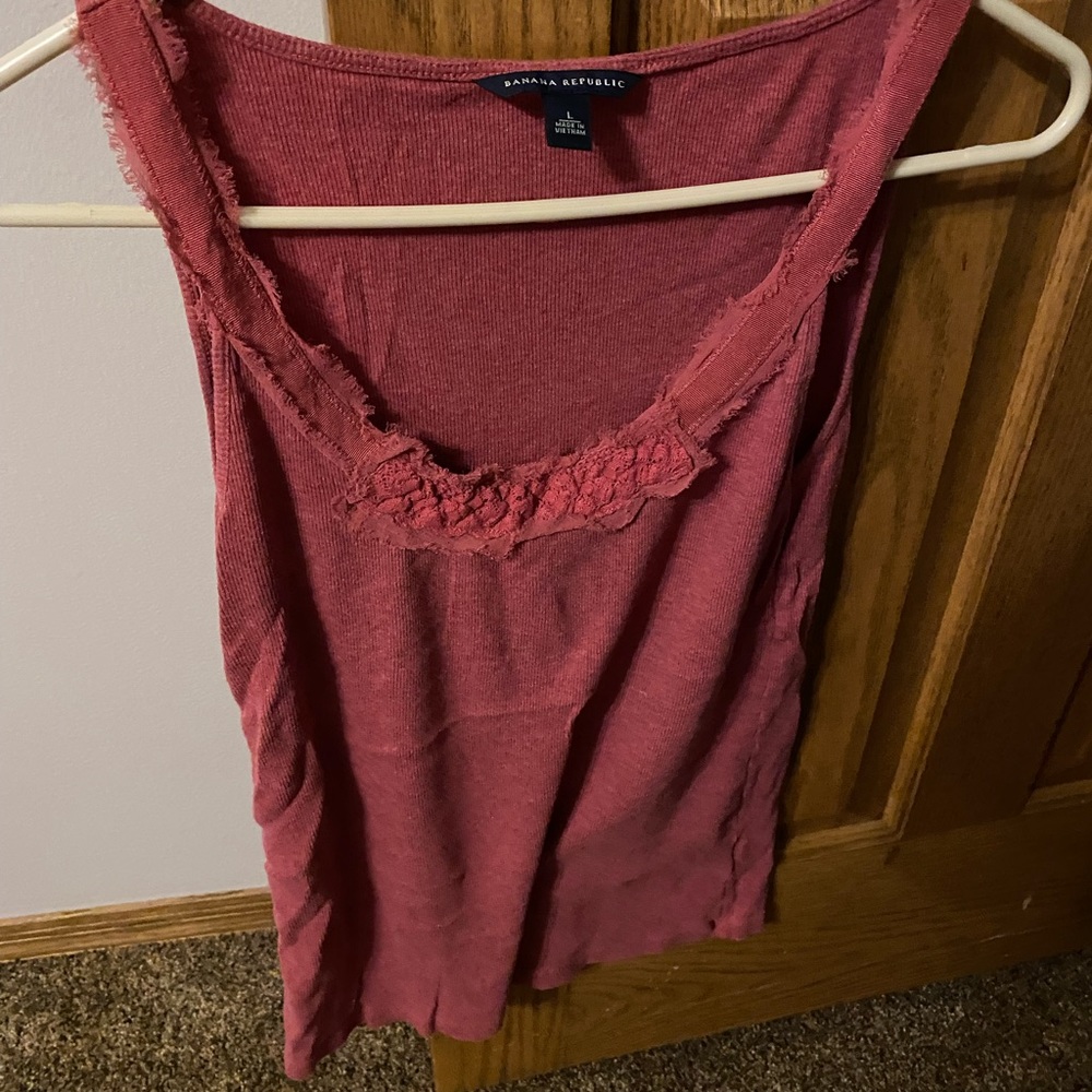 Dark Peachy colored tank, with floral pattern around the neck line!